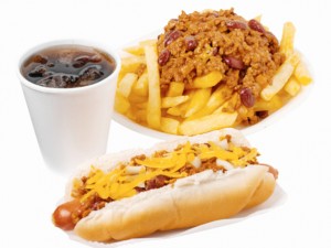 Close-up of hotdog and chili french-fries with cold drink